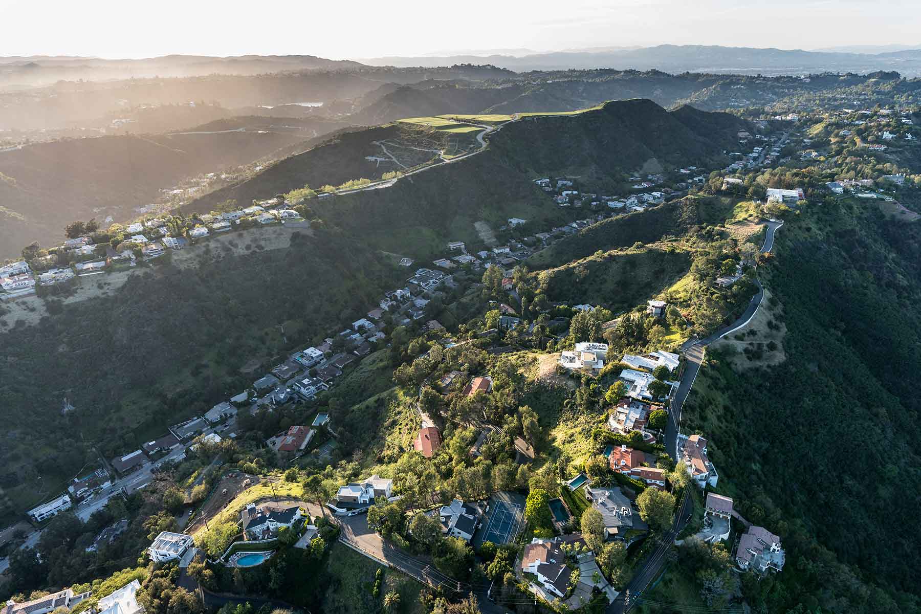 Aerial view of South Beverly Park hilltop homes in the Santa Monica Mountains above Beverly Hills and Los Angeles, California.